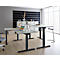 A bright, modern office space with height-adjustable desks and minimalist decor.