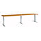 Long, height-adjustable desk with light brown tabletop and silver legs.
