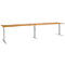 A long, height-adjustable desk with a wooden look and silver legs.