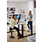 Two women in a bright office at height-adjustable desks. One is sitting on a stool, the other is standing.