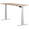 A height-adjustable desk in light wood look with white legs. A control is visible under the tabletop.