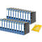 Blue file folders stacked, with a stack of paper next to them. Folders with white labels and black closures.