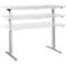 A height-adjustable desk in white and gray against a white background.
