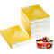 Mehrere Papierstapel mit gelber Verpackung und der Aufschrift Paper@Print. Dazu eine Schale Haribo Color-Rado.