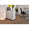 Office with standing desk, office chair, lamp, plant. Wooden floor, white walls, bright furnishings.