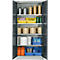 An open grey cabinet with shelves filled with materials, rolls, and containers. The doors are open.