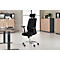 Black office chair with headrest, in front of a bright background. Desk, cabinet and window in the background.