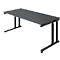 Gray, rectangular desk with black height-adjustable legs. The tabletop is slightly tilted.