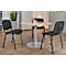 A round table with three chairs in an office. Drinks and a notepad are on the table.