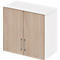 Wall cabinet with two doors made of light wood and white sides. Two metal handles. Simple design.