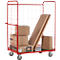 Red transport cart with grids, loaded with boxes and panels. Black loading area, four wheels.