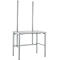 Gray work table with two vertical columns with numerous holes. Metal legs, rectangular table top.