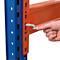 A hand inserts a tool into a hole on an orange shelf post to secure a shelf beam.