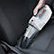 Handheld vacuum cleaner used to clean a car seat. The vacuum is white and grey with a red button.