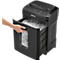 A black paper shredder with its drawer being opened, showing the shredded paper. A hand is holding the handle.
