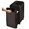 Black paper shredder with open waste bin. Hand opening the bin, filled with shredded papers. "Fellowes" logo.