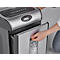 Person opening paper shredder container. Shredded paper strips are visible through the window.