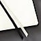 Gros plan sur un carnet ouvert. Marque-pages noir et blanc sur les pages blanches.