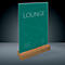 Menu card with green background and white text. Inscription: LOUNGE. Wooden base.