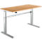 A height-adjustable desk with a light brown tabletop and silver legs, on a white background.