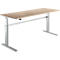 Light brown height-adjustable desk with silver legs. The tabletop is rectangular.