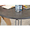 Round, anthracite-colored table. On it an open notebook, water bottles and glasses.