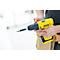 Person holding a yellow cordless drill. A screw attachment extends from the device.