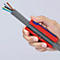 Hand holding cable with red and blue tool, grey corrugated pipe, and colored cable ends.