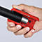 A hand holds a red tool clamping a black, corrugated hose.