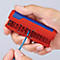 A hand holds a red and blue wire stripper. A blue cable is being processed.