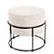 Tabouret rond avec assise beige et structure en métal noir, plante d'intérieur et fenêtre en arrière-plan.