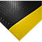 Tapis de sol noir avec bord jaune, motif en losanges. Zone diagonale jaune sur le bord inférieur droit de l'image.