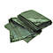 Green tarpaulin, folded. Details: eyelets and reinforced corners. Bright setting.