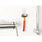 Orange razor in holder next to a towel rack, on white background.