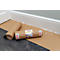 Two brown paper rolls on the floor, one unrolled. In the background a white wall and baseboard.