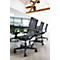 Black office chairs at a table in a bright room.