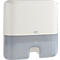 White and gray Tork paper towel dispenser. Rectangular with rounded edges. Transparent lower part.