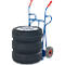 Blue hand truck carrying three tires and a wheel with rim.