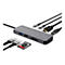 Grauer USB-C-Hub der Marke Trust mit verschiedenen angeschlossenen Kabeln und Speicherkarten auf weißem Hintergrund.