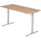 A height-adjustable desk with a light brown table top and silver legs.