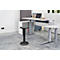 Office stool in front of height-adjustable desk. Desk with laptop, plants. Gray carpet, light walls.