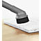 A gray vacuum brush cleans the keys of a white keyboard.