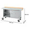 Verrijdbare werkbank: grijze metalen constructie, houten werkblad, kast, lades, 1500x700x840 mm.