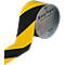 Gerolde gele en zwarte markeringstape rol met de inscriptie "EasyTape".