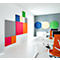 Colorful wall panels adorn an office wall, complemented by round elements on the opposite wall. Desks and orange chairs are distributed in the room.