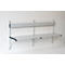 Gray wall-mounted folding bench attached to a white wall.