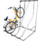 Yellow bicycle in a metal bike rack. The rack has curved rails that make parking easier.