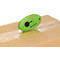 A green box cutter cutting tape on a cardboard box. The brand is Westcott.