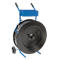 Blue strapping with cart, black spool. One wheel, handles, basket.