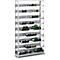Wine rack filled with bottles of wine. White metal frame with multiple shelves.